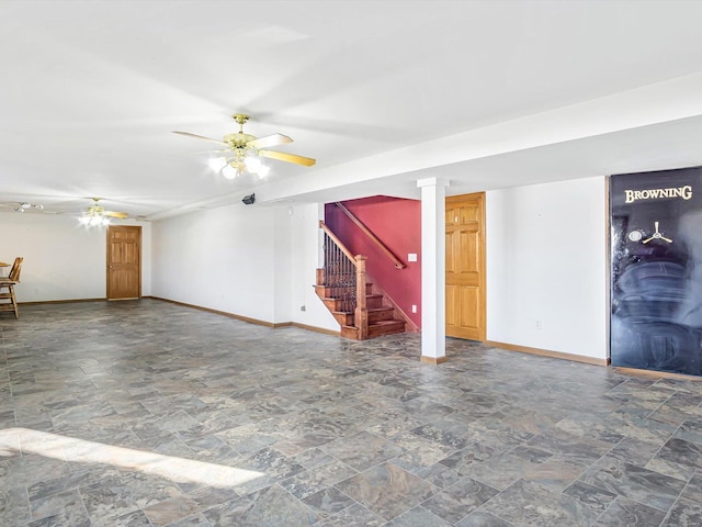 interior space with a ceiling fan, baseboards, and stairs