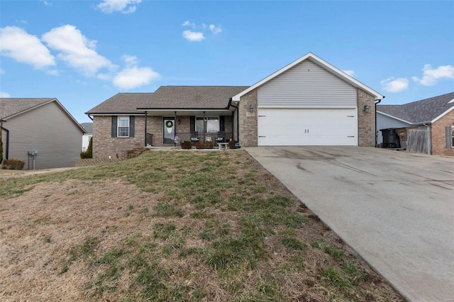 ranch-style house featuring driveway, a porch, an attached garage, a front lawn, and brick siding