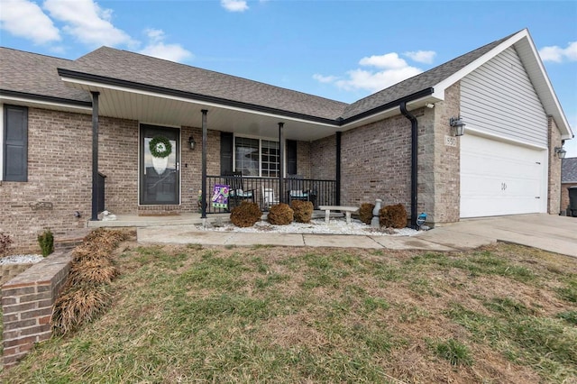 ranch-style home with an attached garage, covered porch, brick siding, a shingled roof, and driveway