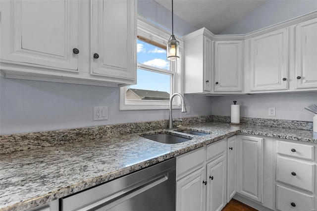 kitchen featuring hanging light fixtures, white cabinets, stainless steel dishwasher, and a sink