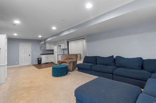 living room with bar, recessed lighting, baseboards, and light carpet