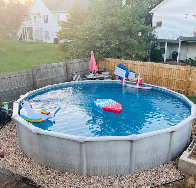 view of pool featuring a fenced in pool, a lawn, and a fenced backyard