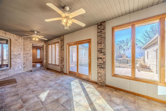 unfurnished sunroom with wooden ceiling