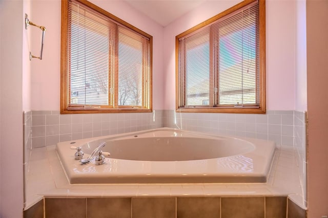 full bathroom featuring plenty of natural light and a bath