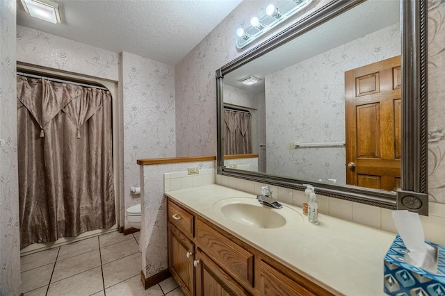 full bathroom with a textured ceiling, toilet, and wallpapered walls