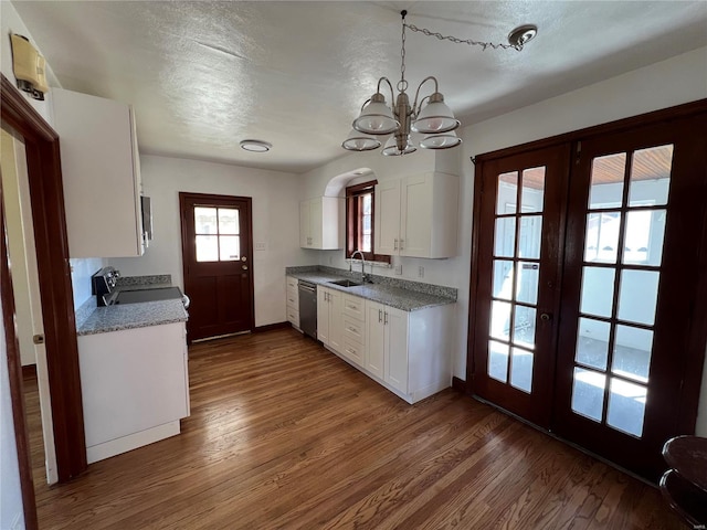 kitchen featuring a sink, white cabinets, french doors, stainless steel dishwasher, and dark wood-style floors