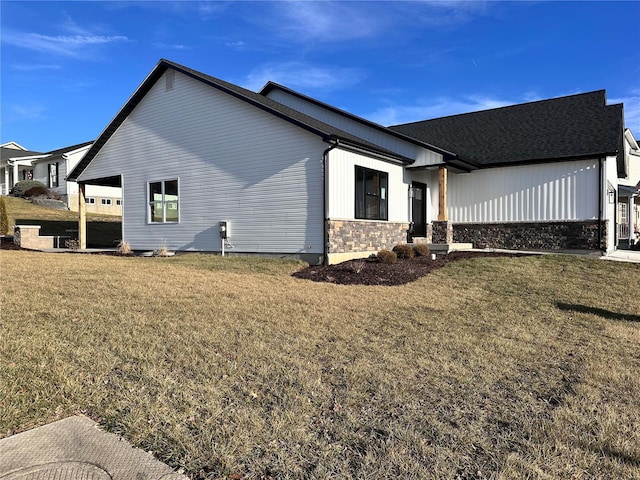 view of home's exterior featuring stone siding and a yard