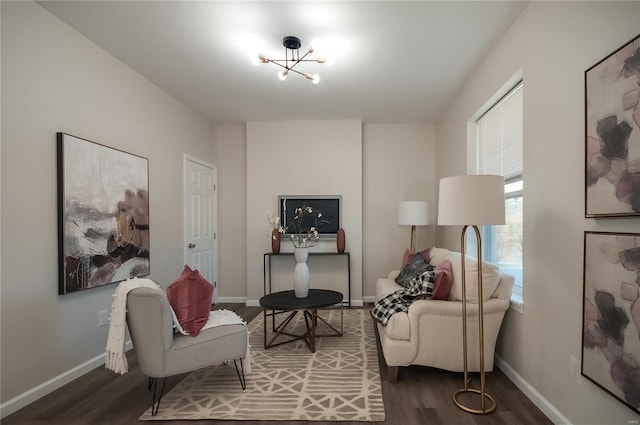 living area with baseboards and wood finished floors