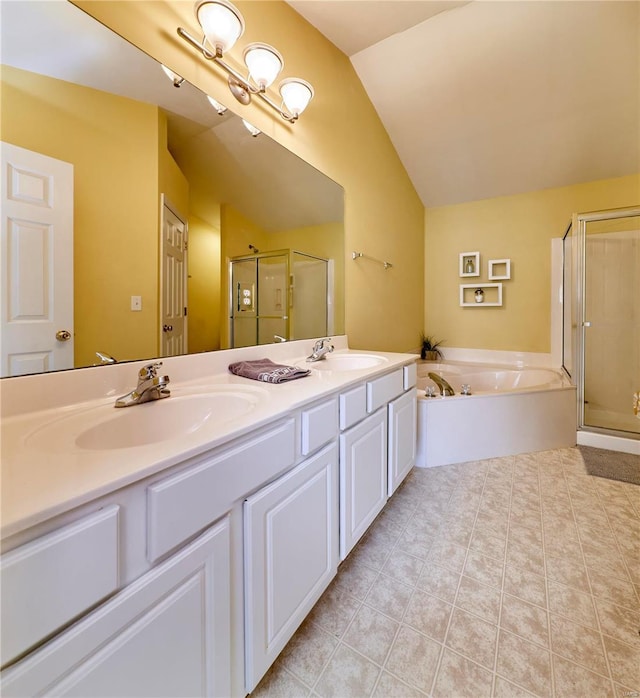 bathroom with lofted ceiling, a sink, a bath, and tile patterned floors