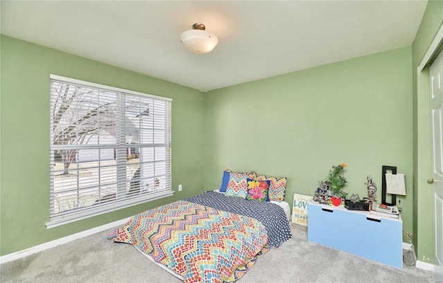 bedroom featuring carpet and baseboards