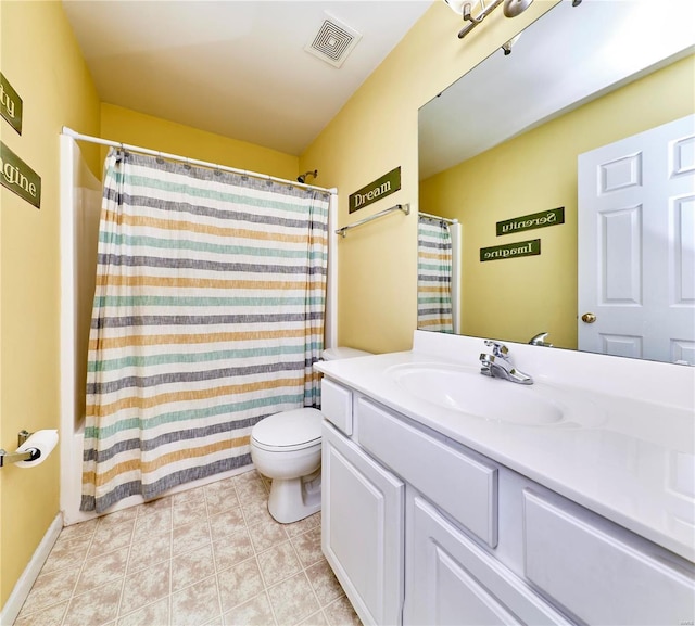 bathroom featuring toilet, vanity, visible vents, and tile patterned floors