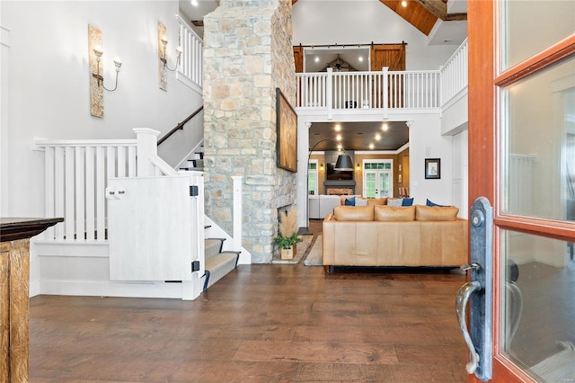 entrance foyer featuring stairway, a high ceiling, and wood finished floors