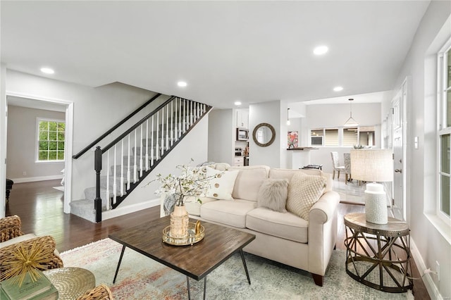 living room with baseboards, stairway, wood finished floors, and recessed lighting