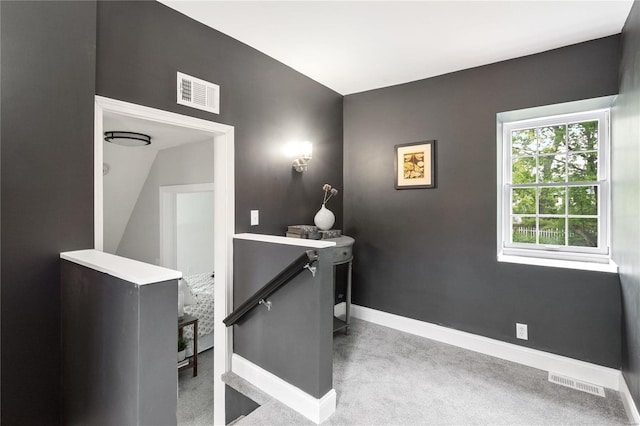 home office featuring carpet floors, visible vents, and baseboards