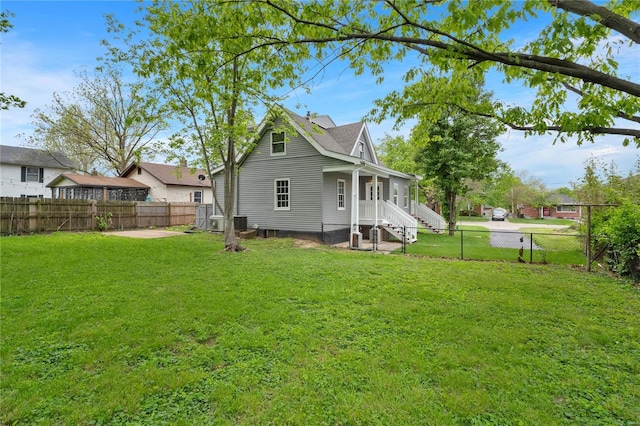 back of property featuring a yard and a fenced backyard