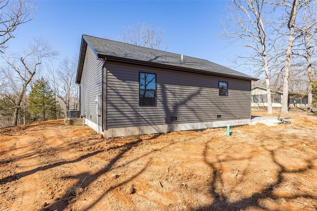 view of home's exterior featuring cooling unit and crawl space