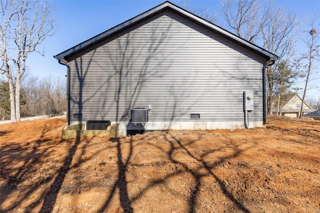 view of side of home with crawl space and cooling unit