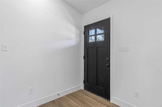 foyer entrance featuring light wood-style flooring and baseboards