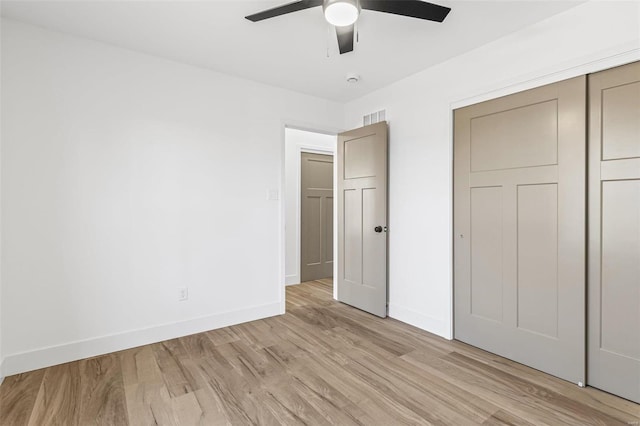 unfurnished bedroom with baseboards, visible vents, and light wood-style floors