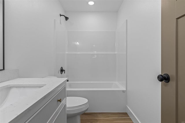 full bath with vanity, shower / bathing tub combination, wood finished floors, and toilet