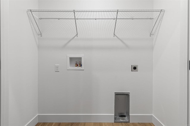 laundry room with laundry area, baseboards, wood finished floors, washer hookup, and electric dryer hookup