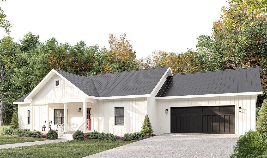 modern inspired farmhouse featuring metal roof, driveway, a porch, and an attached garage