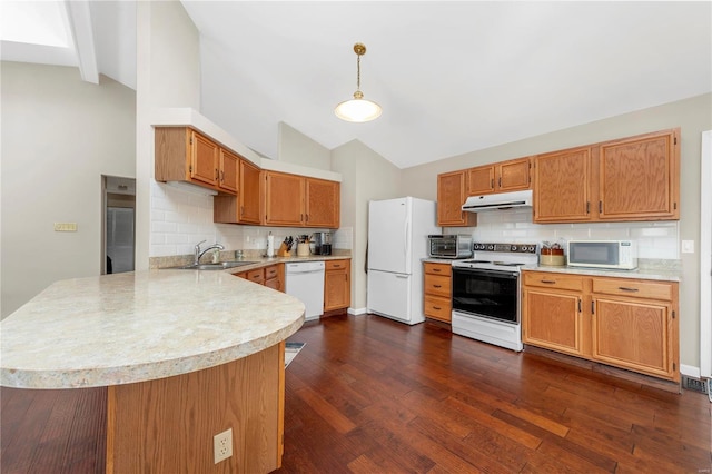 kitchen with under cabinet range hood, a peninsula, white appliances, a sink, and light countertops