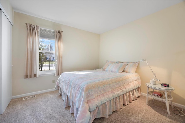 carpeted bedroom featuring visible vents and baseboards