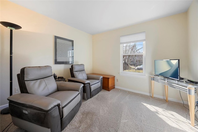 living area with visible vents, baseboards, and carpet flooring