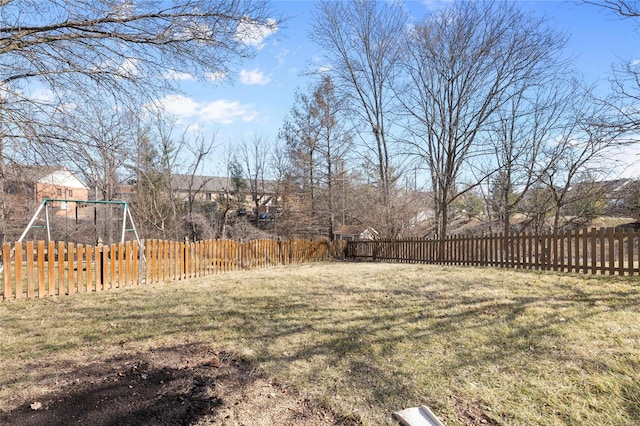 view of yard with fence and a playground