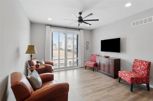 living room with a ceiling fan, light wood-type flooring, visible vents, and recessed lighting