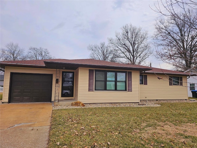 ranch-style house with a front lawn, driveway, and an attached garage