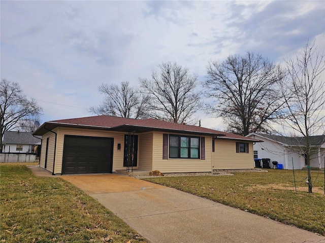 ranch-style home featuring a garage, driveway, and a front lawn