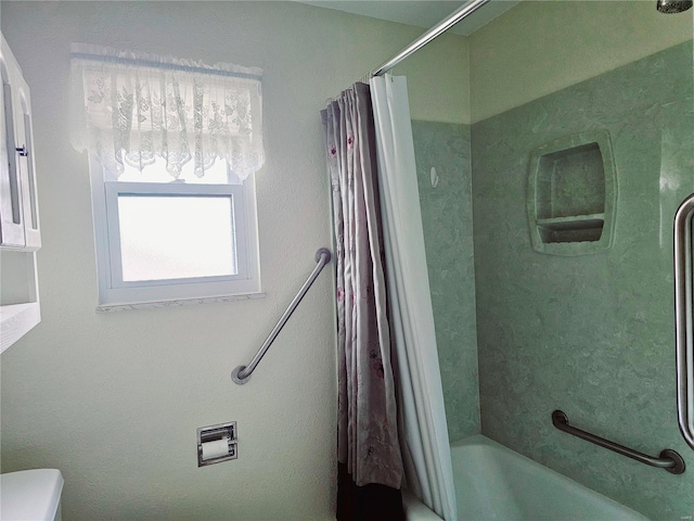 bathroom with shower / tub combo with curtain and toilet