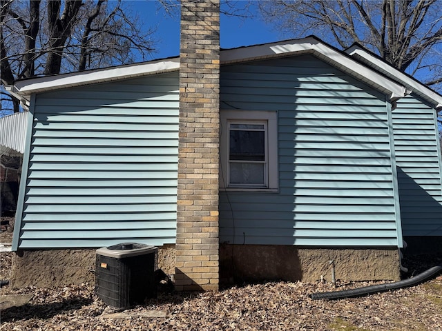 view of side of home featuring central AC unit