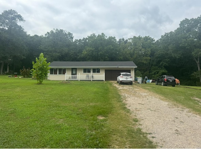 view of front of home with driveway, a porch, and a front yard