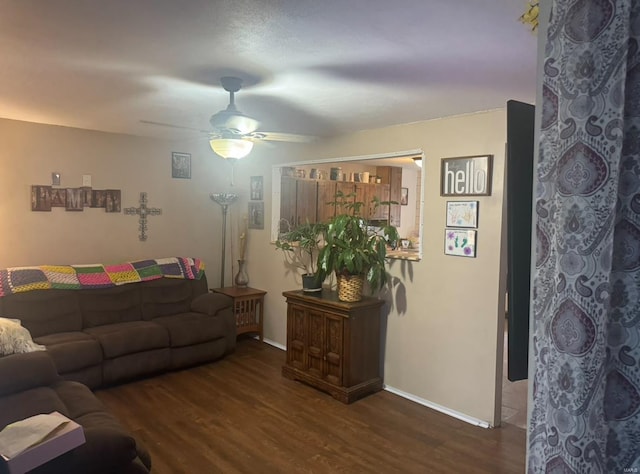 living room featuring ceiling fan, dark wood-style flooring, and baseboards