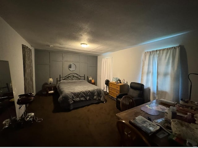 carpeted bedroom with a decorative wall and a textured ceiling