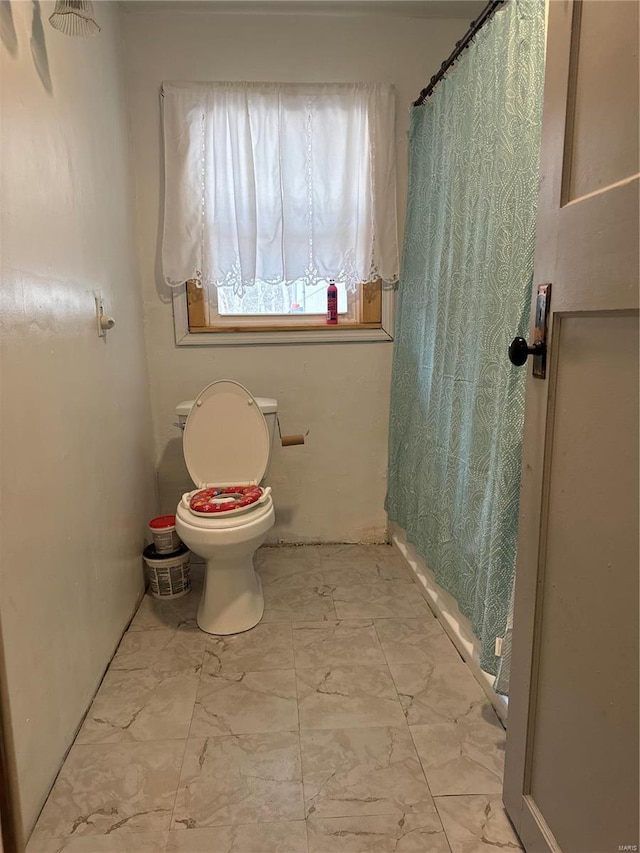 full bath with toilet and marble finish floor