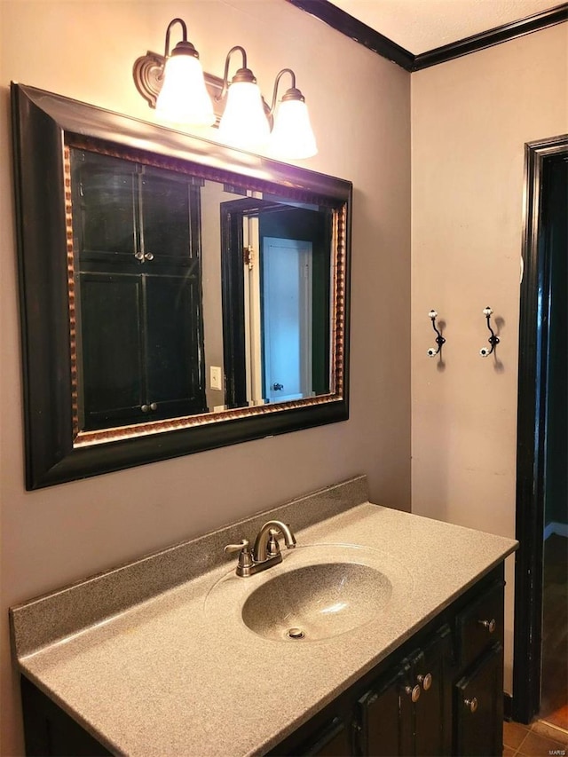 bathroom featuring crown molding and vanity