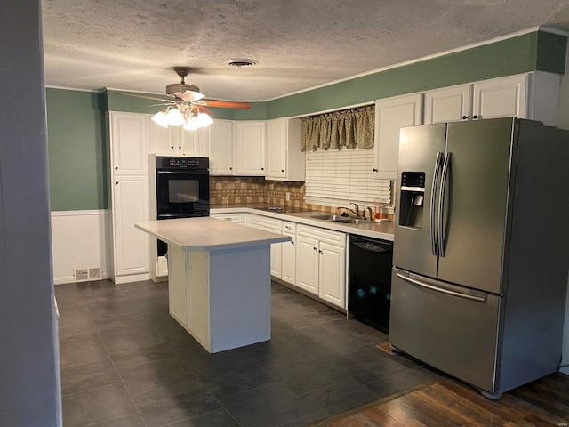 kitchen with visible vents, dishwasher, stainless steel fridge with ice dispenser, white cabinetry, and a sink