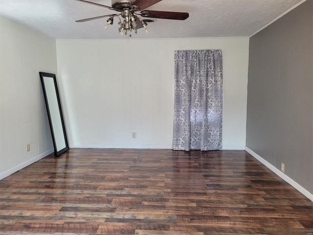 empty room featuring ceiling fan, a textured ceiling, baseboards, and wood finished floors