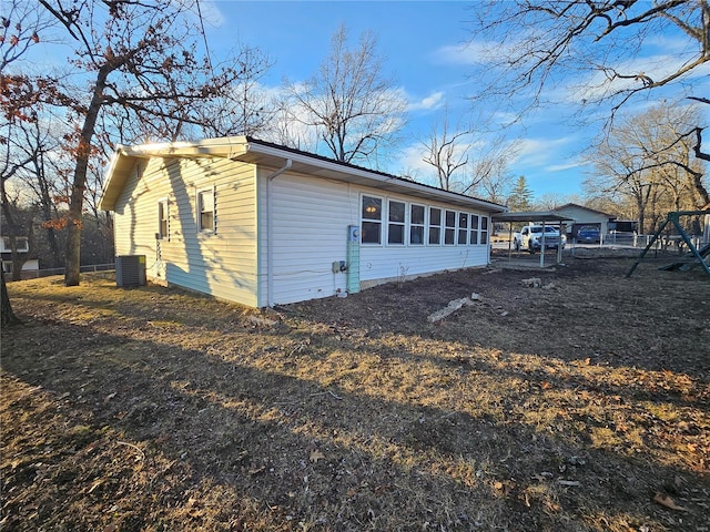 view of side of property featuring fence