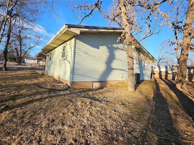 view of property exterior with fence