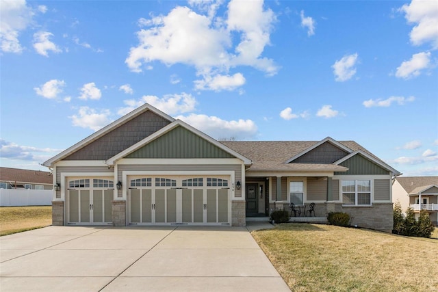 craftsman inspired home with driveway, stone siding, an attached garage, and a front yard