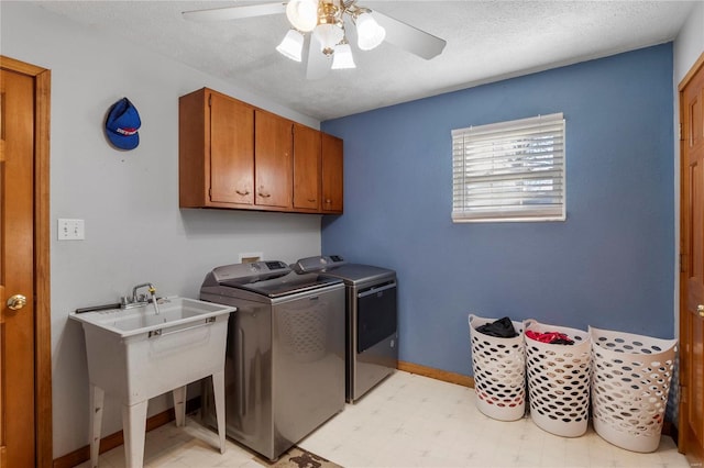 laundry area featuring cabinet space, washer and clothes dryer, a ceiling fan, a textured ceiling, and light floors