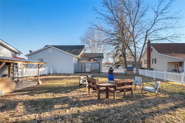 view of yard featuring a fire pit, fence, and a patio