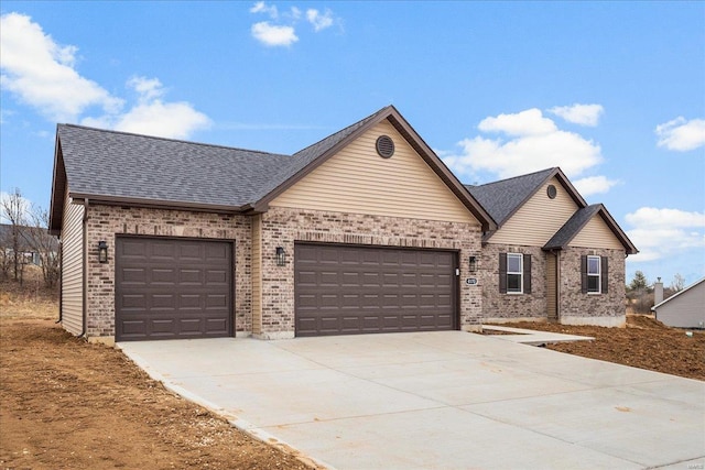 view of front of property with a garage, concrete driveway, a shingled roof, and brick siding