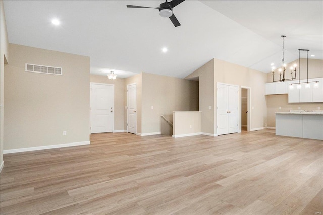 unfurnished living room with visible vents, light wood finished floors, and ceiling fan with notable chandelier