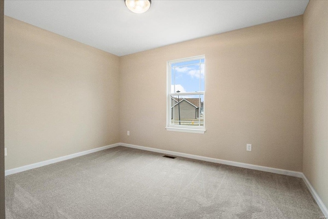 unfurnished room with baseboards, visible vents, and carpet flooring